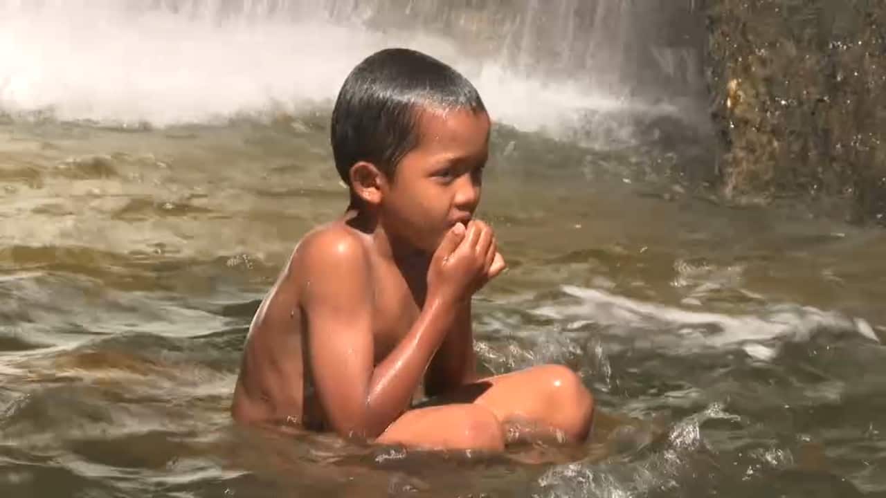 A child cools off in the heat