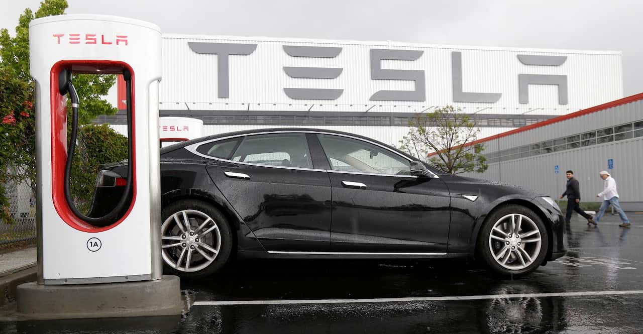 A file image of a Tesla vehicle parked at a charging station outside of the Tesla factory in Fremont, California on May 14
