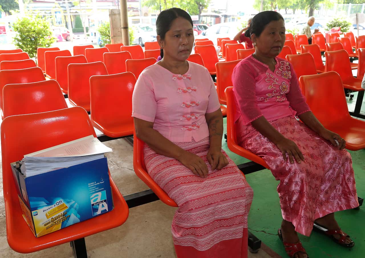 May Thein, mother of Myanmar Wai Phyo, left, and Phyu Shwe Nu, mother of Myanmar Zaw Lin, sit next to petition royal pardon document box at Bangkwang prison.