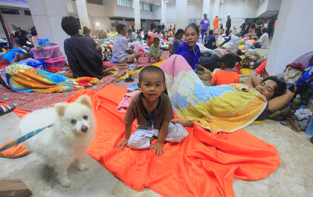 Hundreds sleep at an evacuation center in Nakhon Si Thammarat province.
