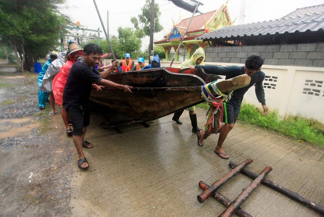Local fishermen move a boat ashore. 