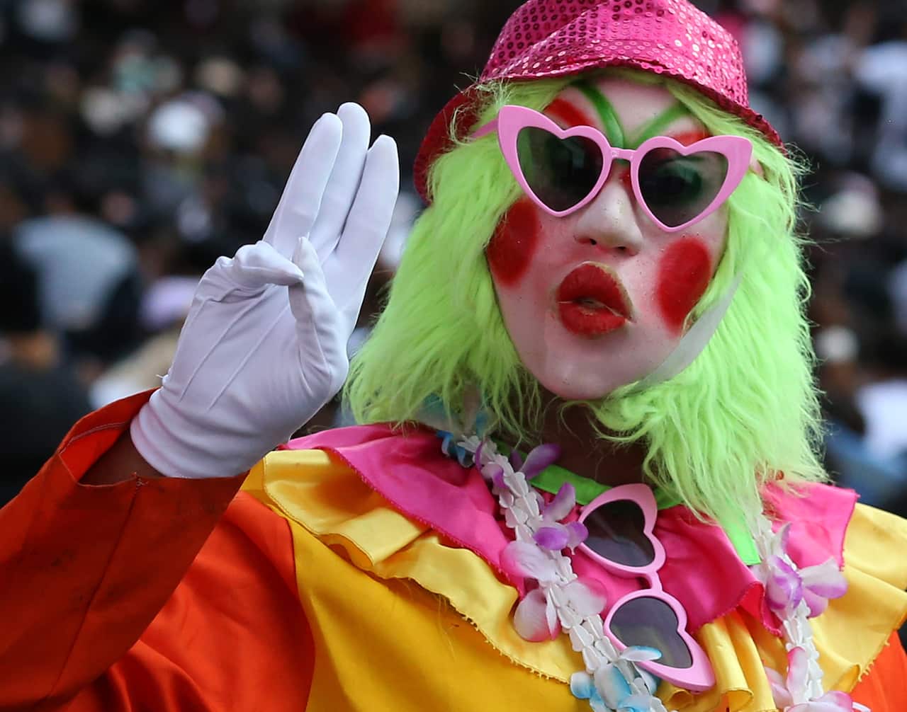 A anti-government protester flashing the three-finger salute joins a rally against the state of emergency in Bangkok, Thailand, 15 October 2020. 
