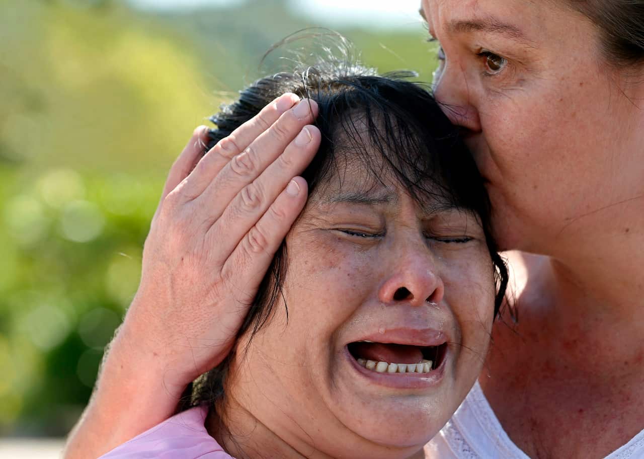 Thein (L), the mother of Wai Phyobreaks into tears following the 2014 decision from the court. 
