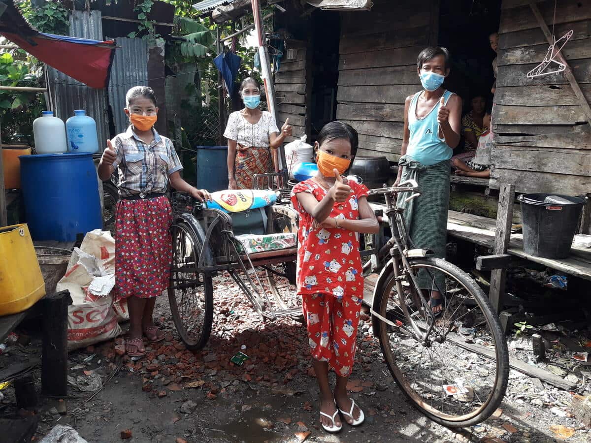 Thandar Win and her family pose with her father's trishaw.