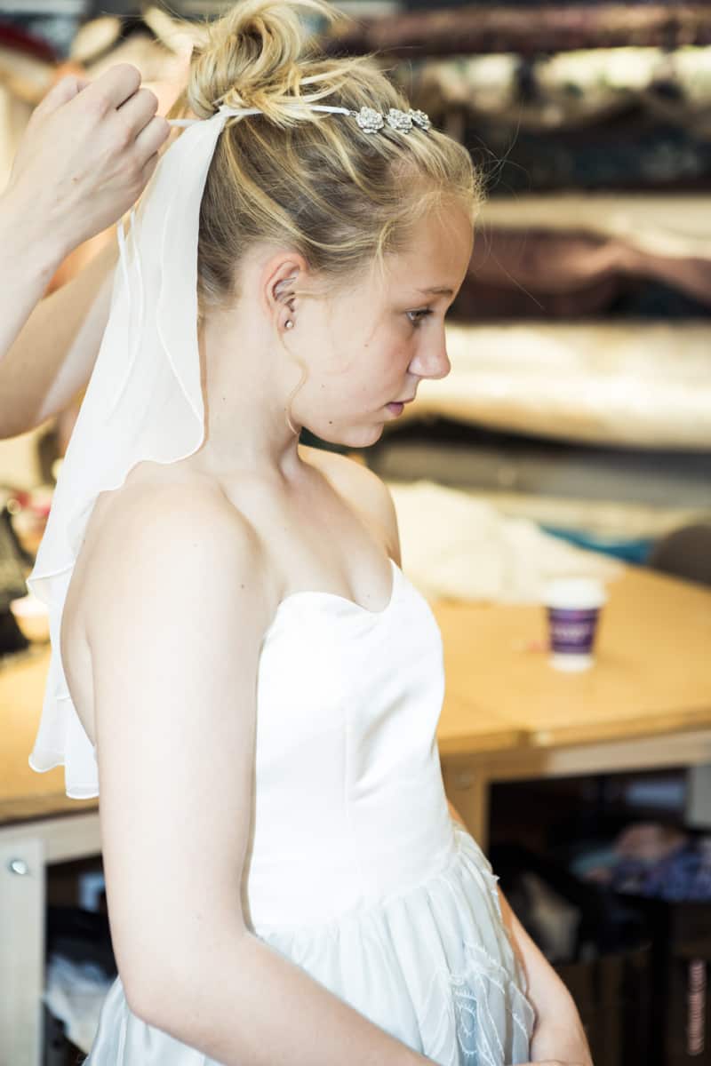 Thea, 12, tries on a wedding dress.