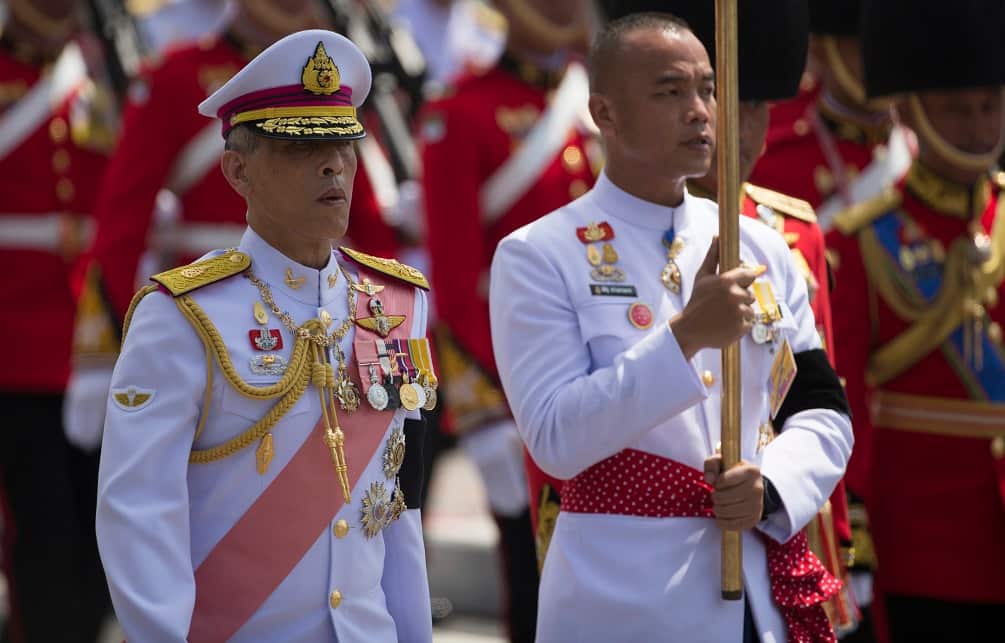 Thai King Maha Vajiralongkorn, left walks during a procession moving his father, late King Bhumibol Adulyadeja.