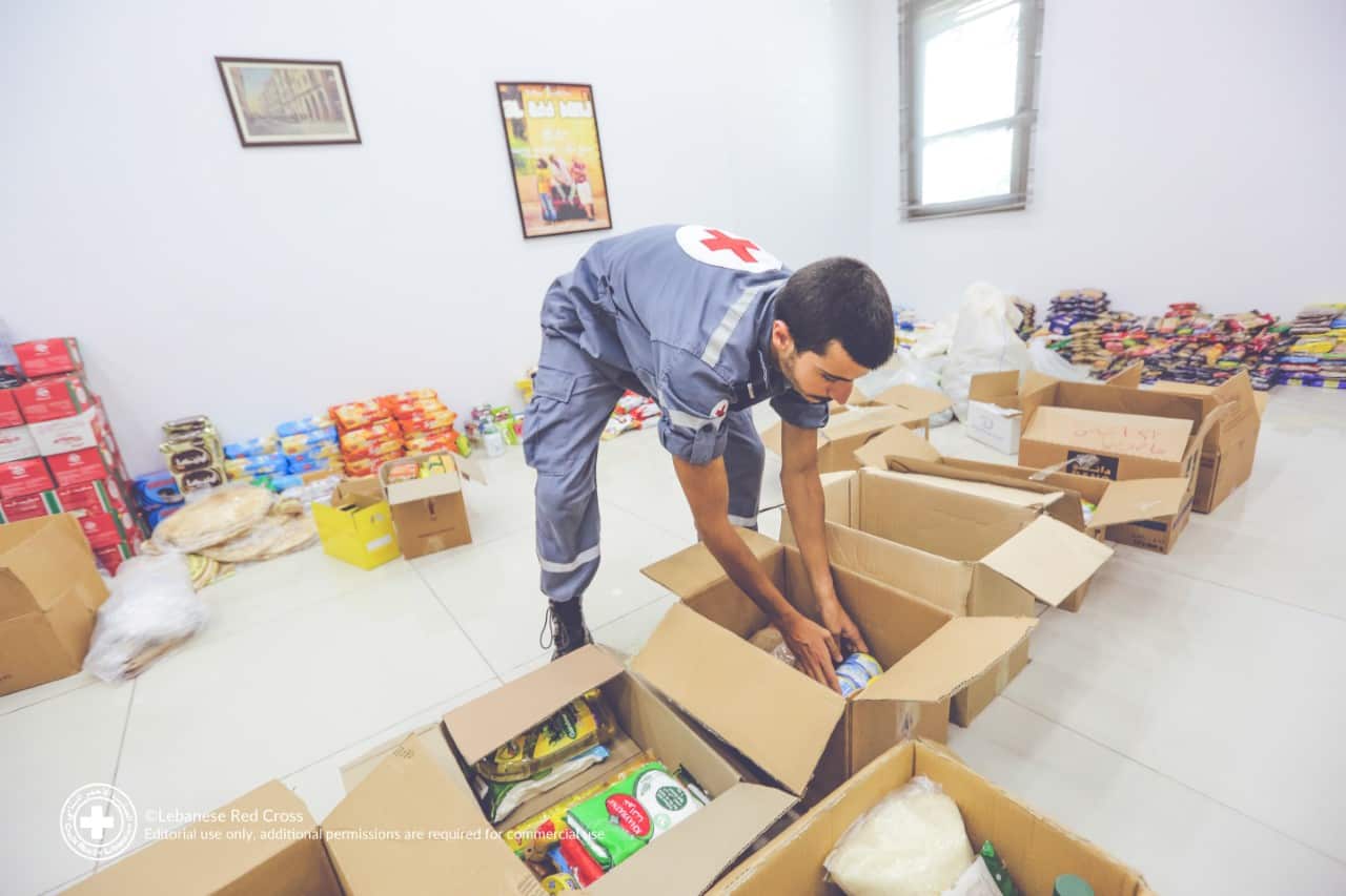 Lebanese Red Cross volunteers unpack donations following the Beirut port explosion.
