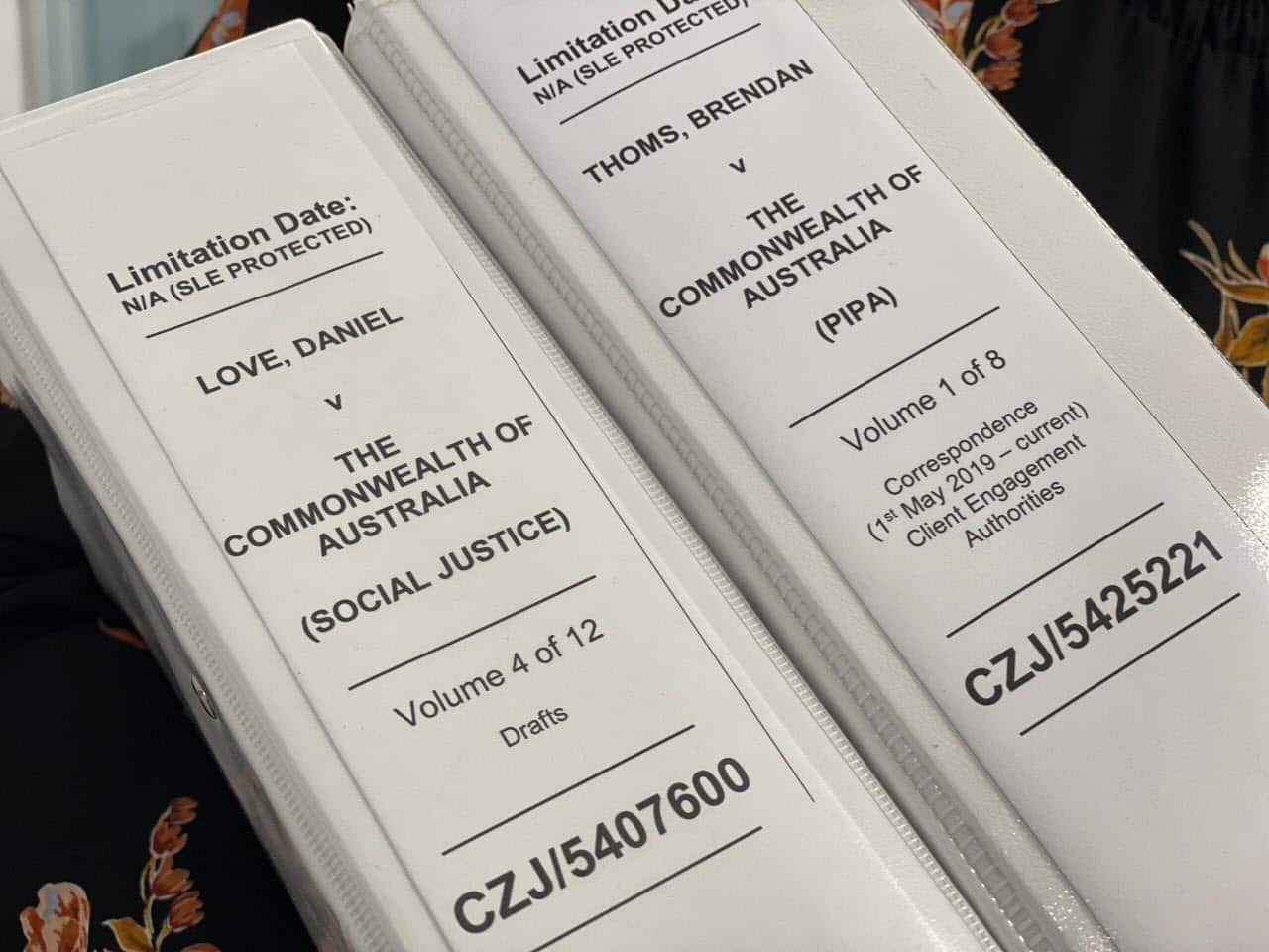 Claire Gibbs holds legal files on Daniel Love and Brendan Thoms