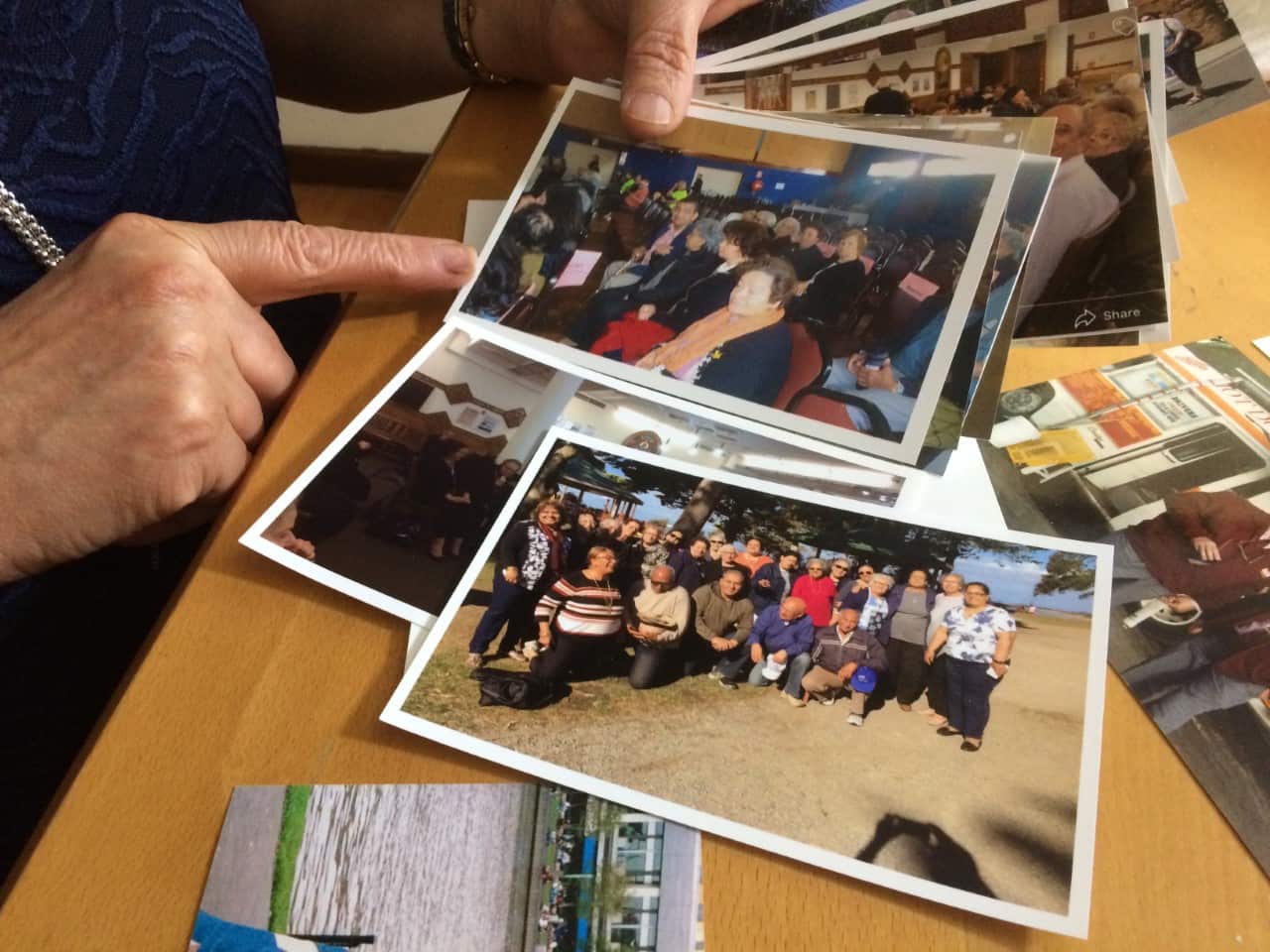 Souria with old photos from the group's outings