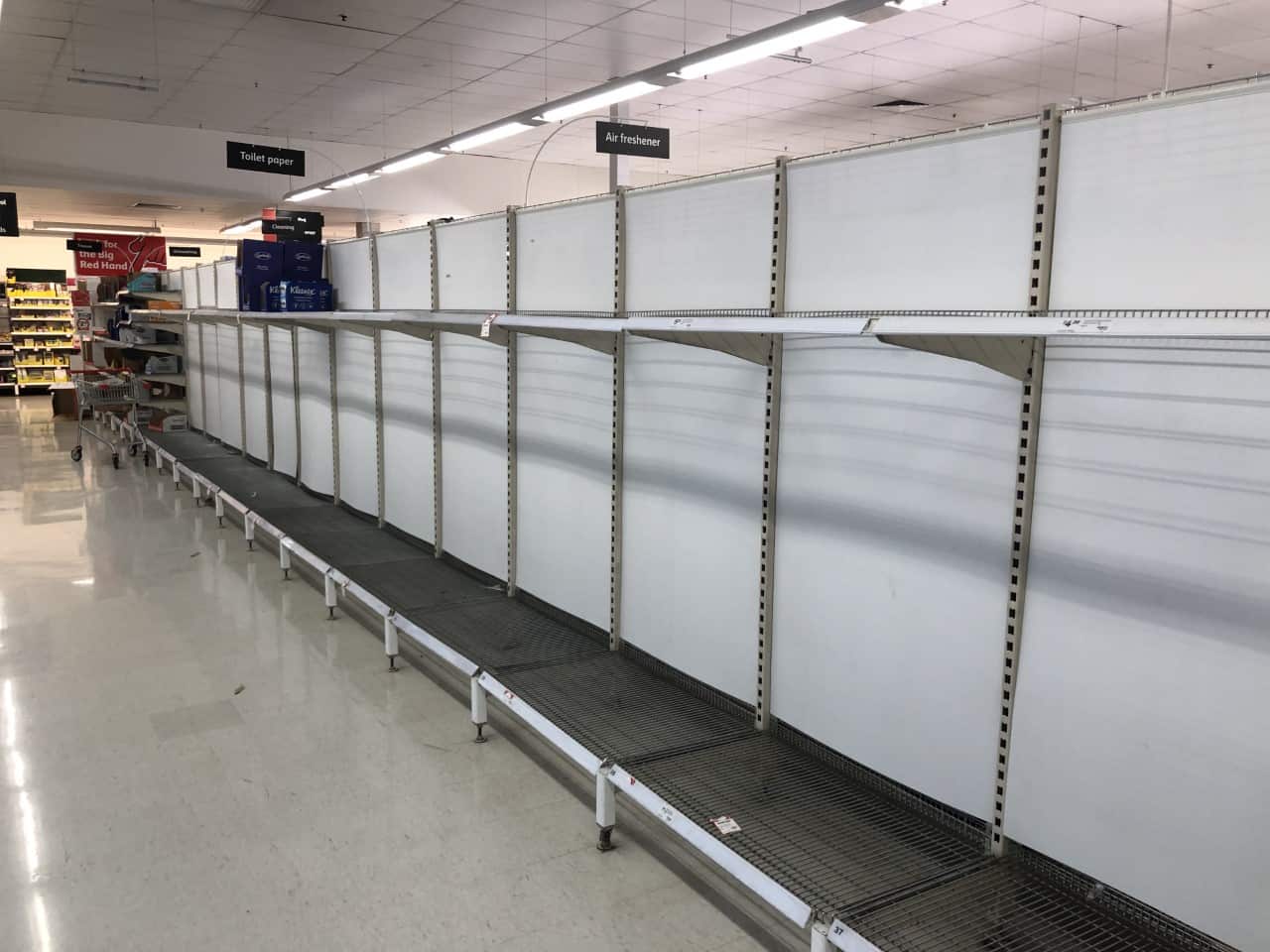 Empty toilet paper shelves at a Coles supermarket. 