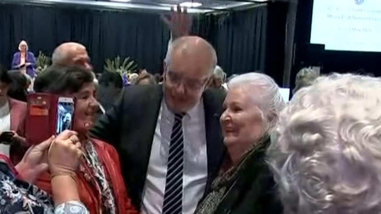 The moment a protester allegedly attempted to crack an egg on Prime Minister Scott Morrison.