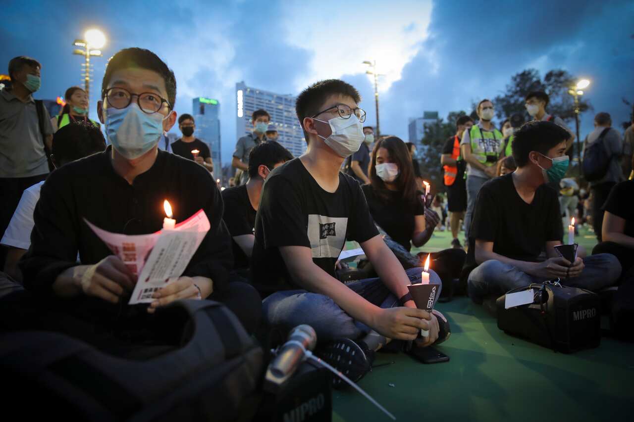 A Hong Kong democracy activist holds a candle in June 2020 as he joins others for a vigil to remember the victims of the 1989 Tianenmen Square protests.