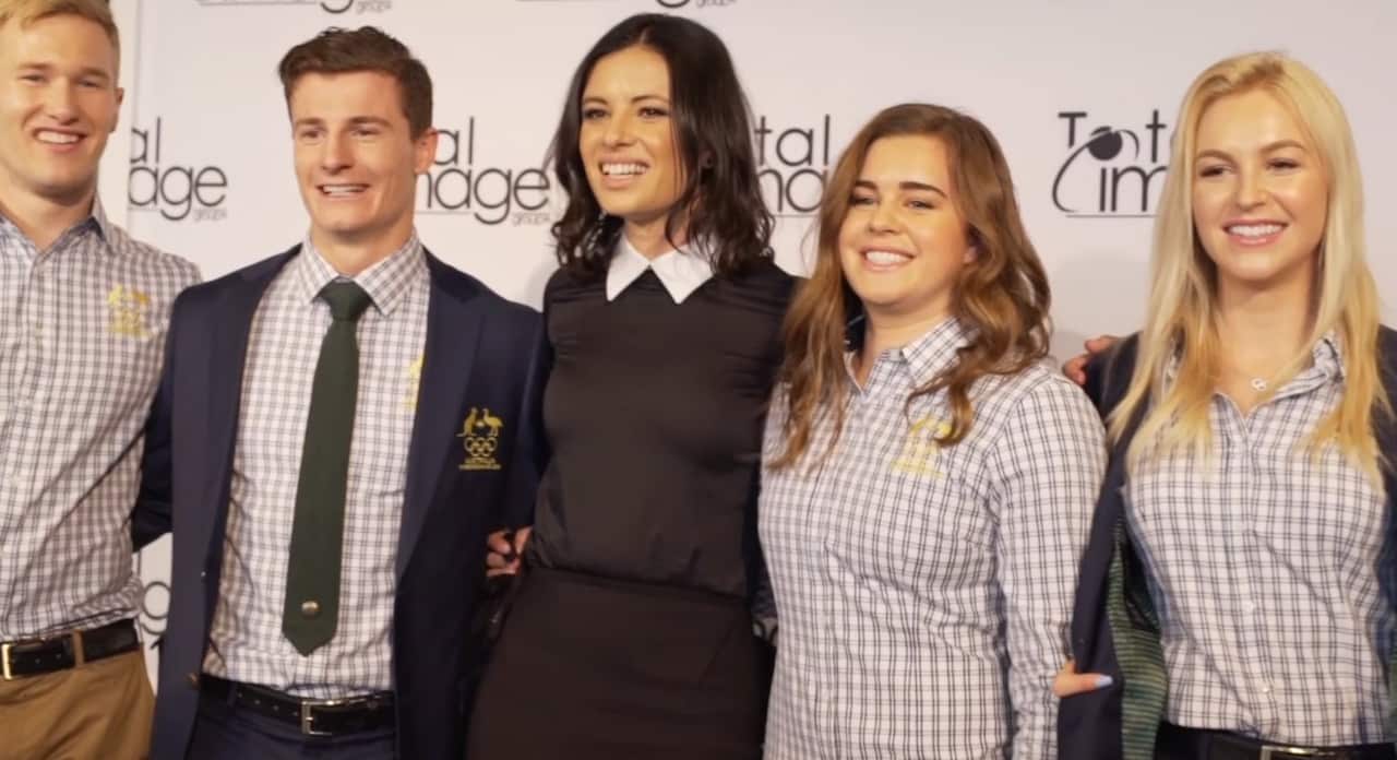 Pamela with Australian athletes in their official Olympic uniforms.
