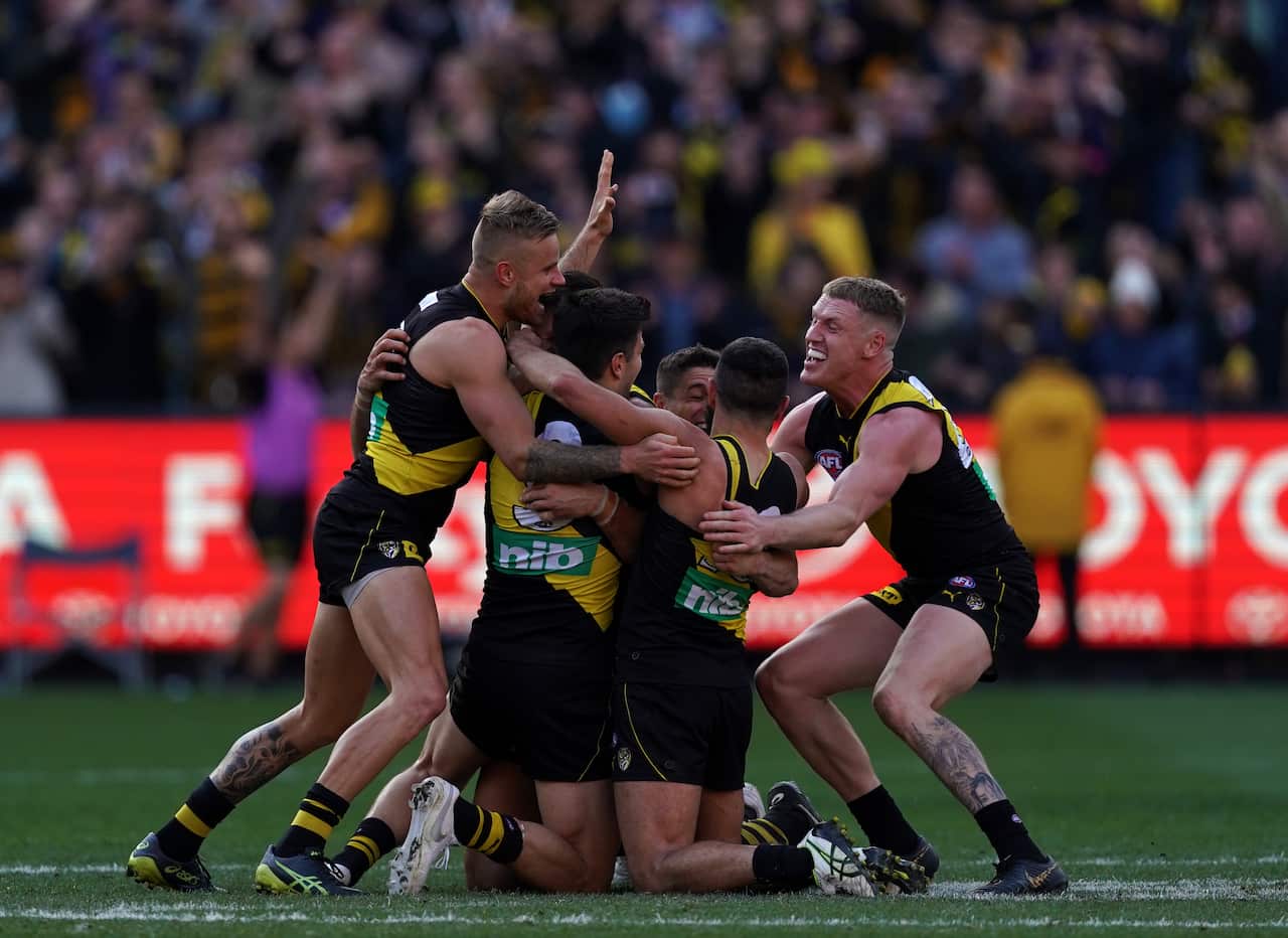 Brandon Ellis (left) and Josh Caddy (right) of the Tigers celebrates with teammates as the buzzer goes.