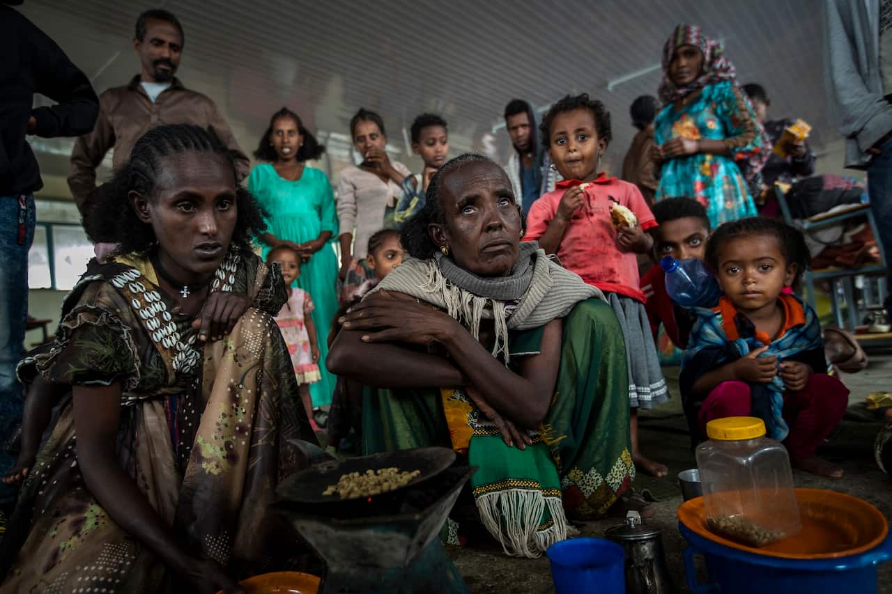 Tigrayan women Tarik (centre) and Meresaeta (left) fled from the town of Samre and now live at the Hadnet General Secondary School in Mekele, Tigray.