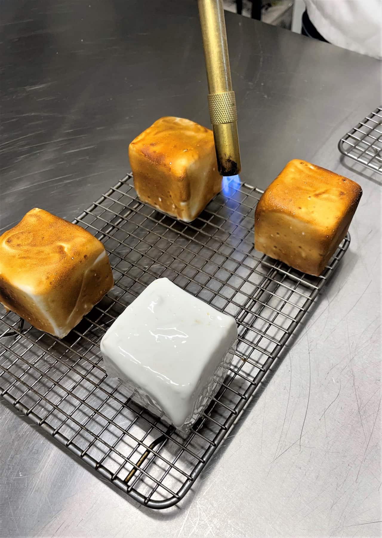 The yuzu lamington has a lightly toasted meringue covering.