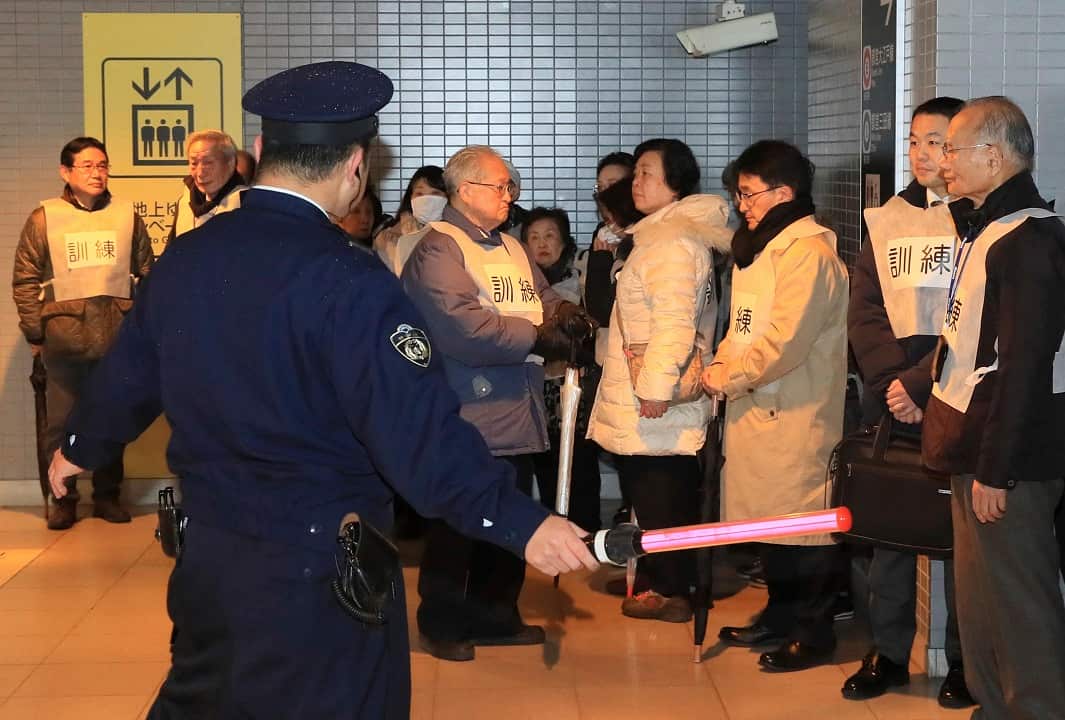 Participants, residents and office workers evacuate during a drill under assumption that a ballistic missile launched in Bunyo Ward, Tokyo on 22 January, 2018.
