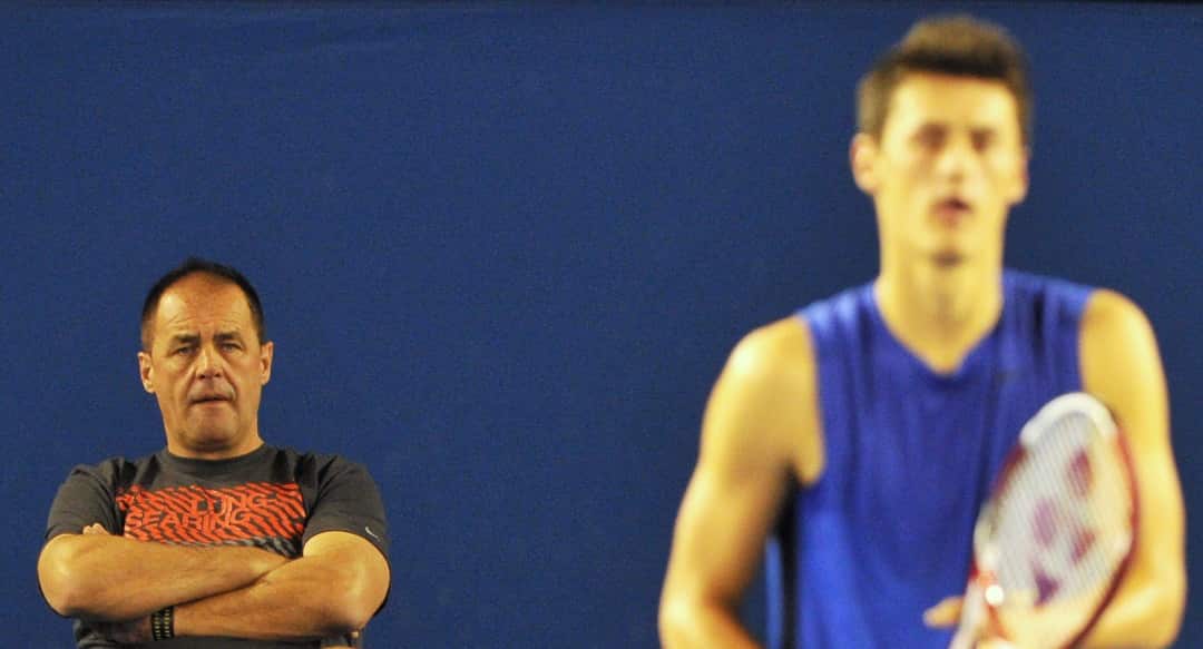 John Tomic watches his son Bernard Tomic of Australian train at Rod Laver Arena in Melbourne, Wednesday, Jan. 11, 2012. The Australian Open Tennis Tournament runs January 16 - 29. 2012. (AAP Image/Julian Smith) NO ARCHIVING, EDITORIAL USE ONLY