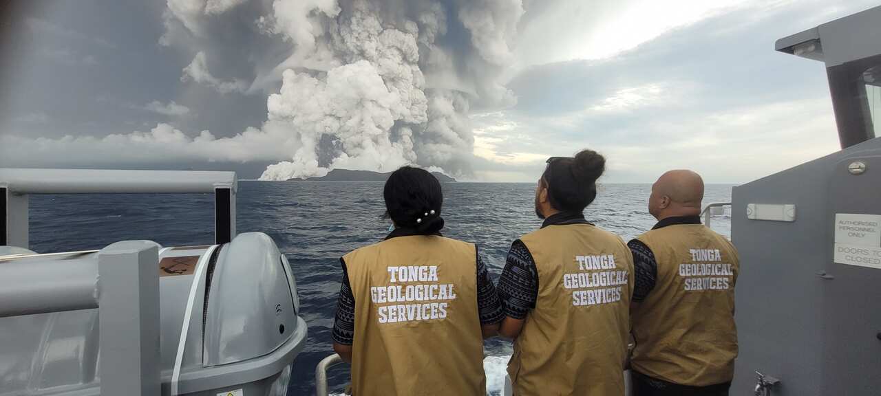 A team of scientists observe the volcano on 14 January, a day before its violent eruption. 