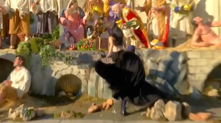 The activist was stopped by police as she grabbed the baby Jesus statue. 