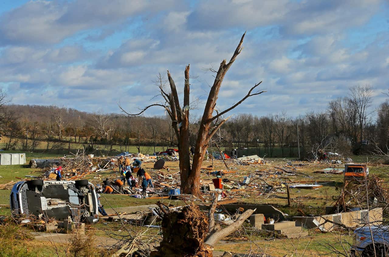 Residents survey the damage on Highway F in Defiance in Missouri.