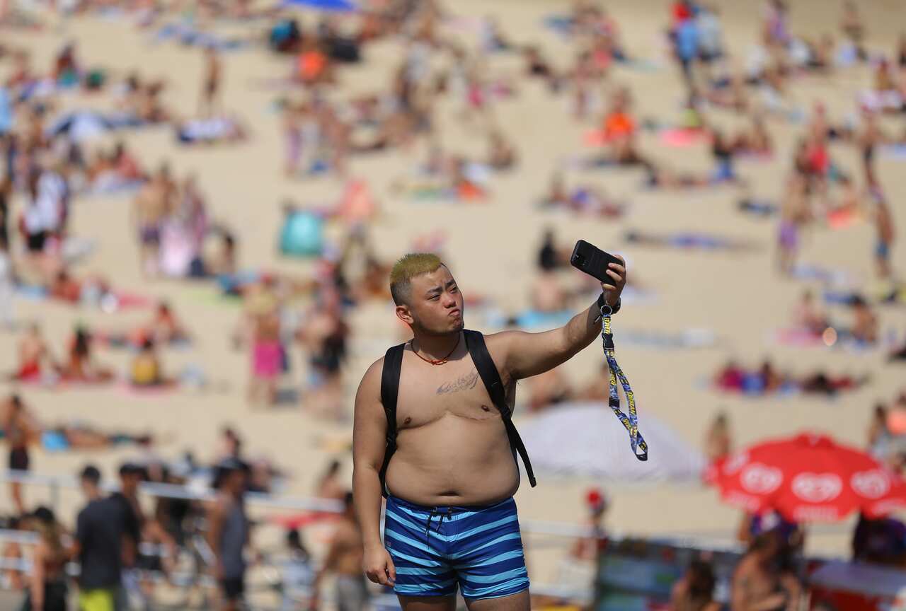 A tourist takes a selfie at Bondi Beach in Sydney. The government is rolling out a $76 million tourism campaign.