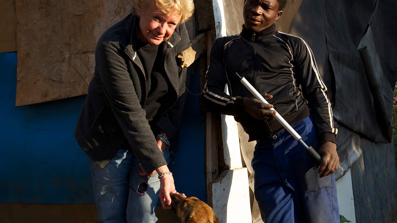 Cora and Moses, a young man she met as a small boy, with his dog Razor - "Moses is a child I first came across some years ago when he was literally scavenging on the dump for food. He comes to me when he needs me or when life is just too hard."