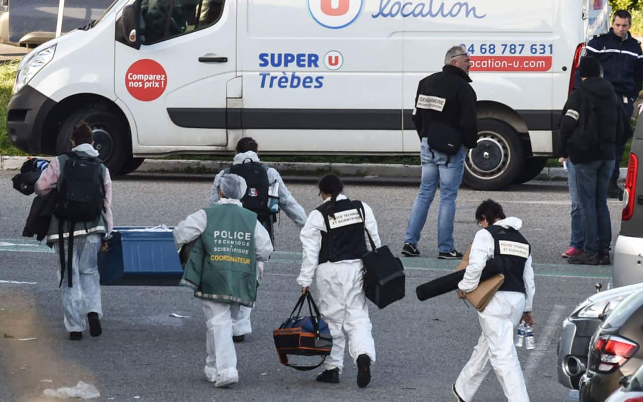 French forensic officers carry away material after a man took hostages at the Super U supermarket in the town of Trebes, southern France on March 23, 2018.