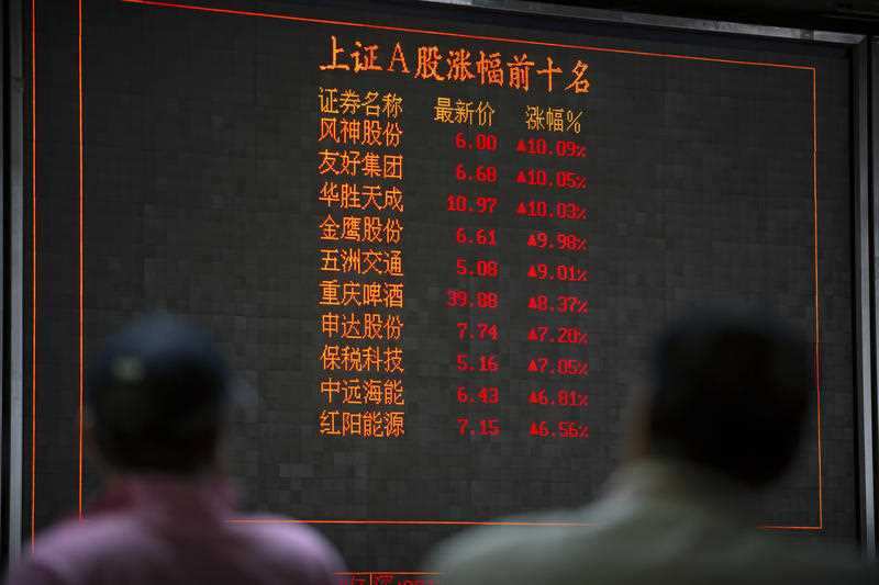 Chinese investors monitor stock prices at a brokerage house in Beijing.