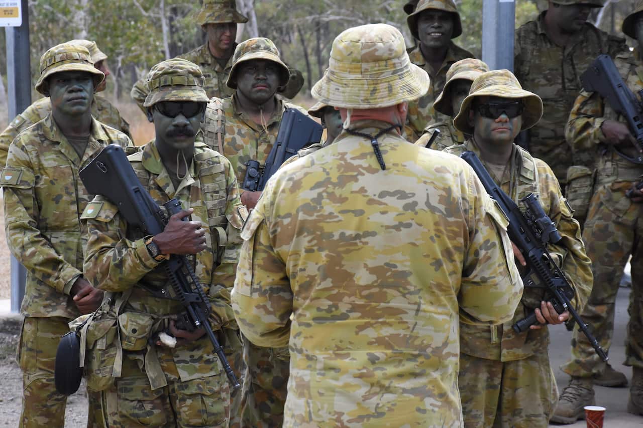 Soldiers from the 51st Battalion get a briefing before heading to the rifle range.