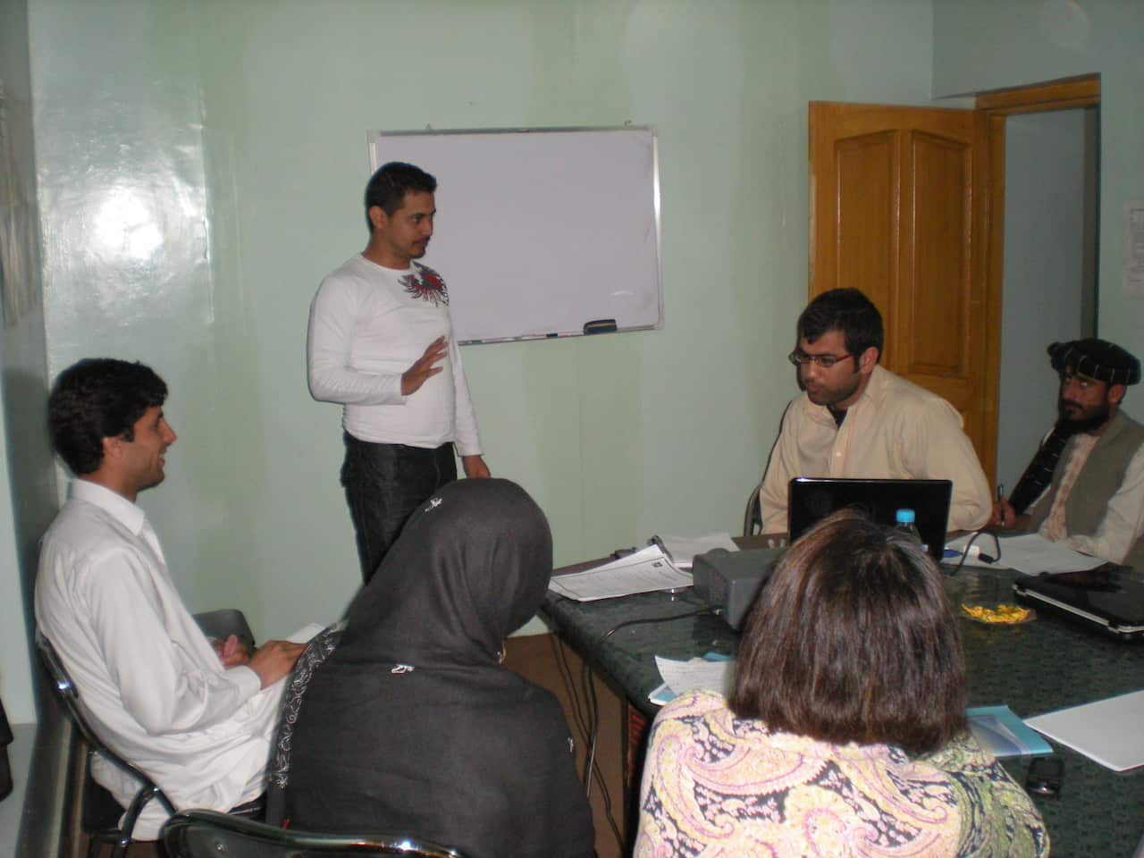 Momand in Afghanistan training staff on microfinancing in a community bank.