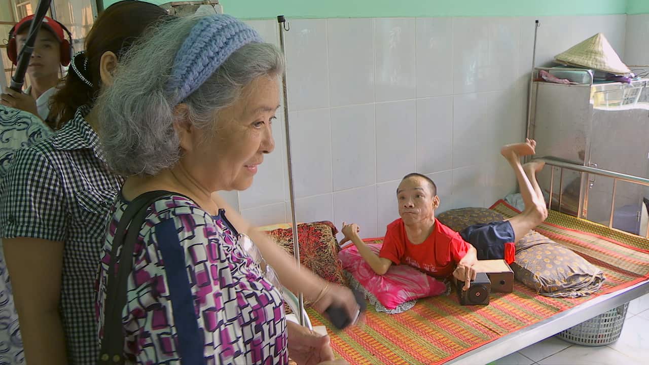 Tran To Nga visits people impacted by Agent Orange.