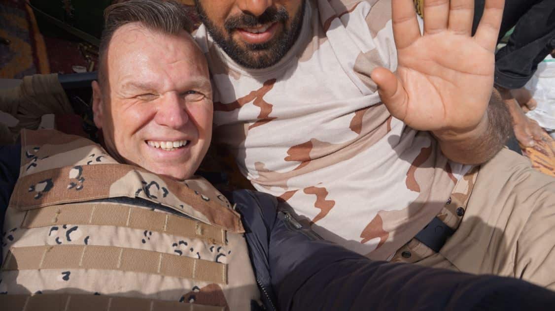 Andrew Drury takes a selfie in a trench in Iraq