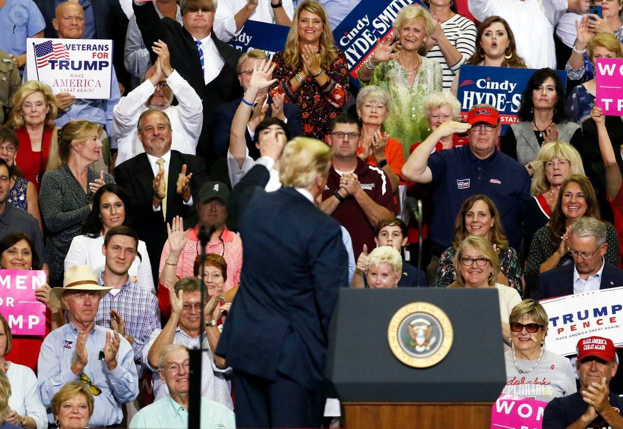 The audience applauds as President Donald Trump speaks at a rally Tuesday, Oct. 2, 2018, in Southaven, Miss.