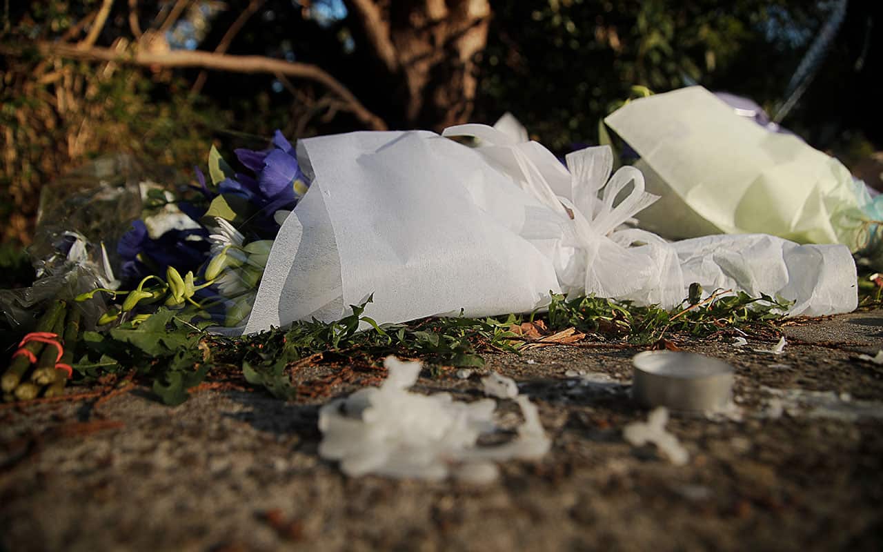 Flowers and tributes are seen at a property in West Pennant Hills, Sydney, Saturday, July 7, 2018.