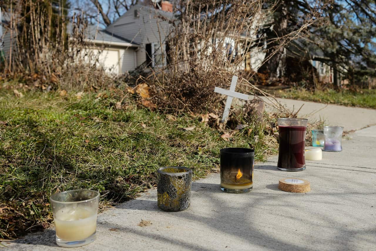 A small set of candles are placed near the site of a fatal police shooting.