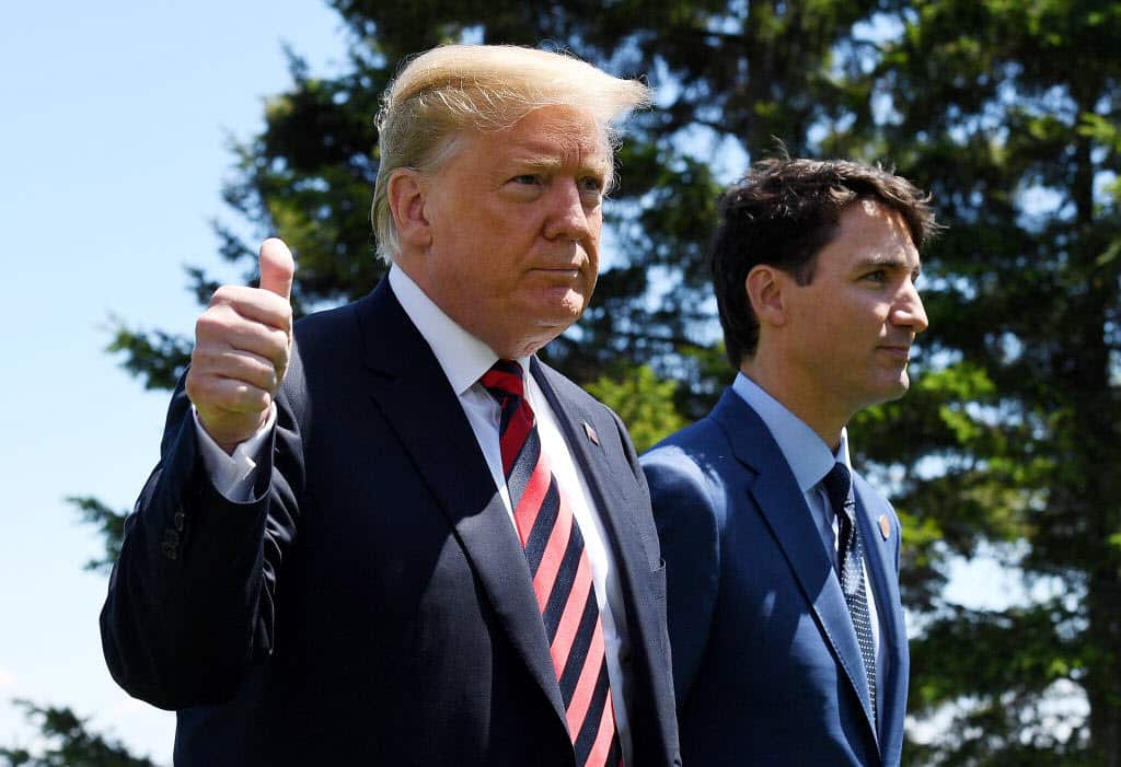 Donald Trump (L) gives a thumbs up to the media as he is greeted by Prime Minister of Canada Justin Trudeau.
