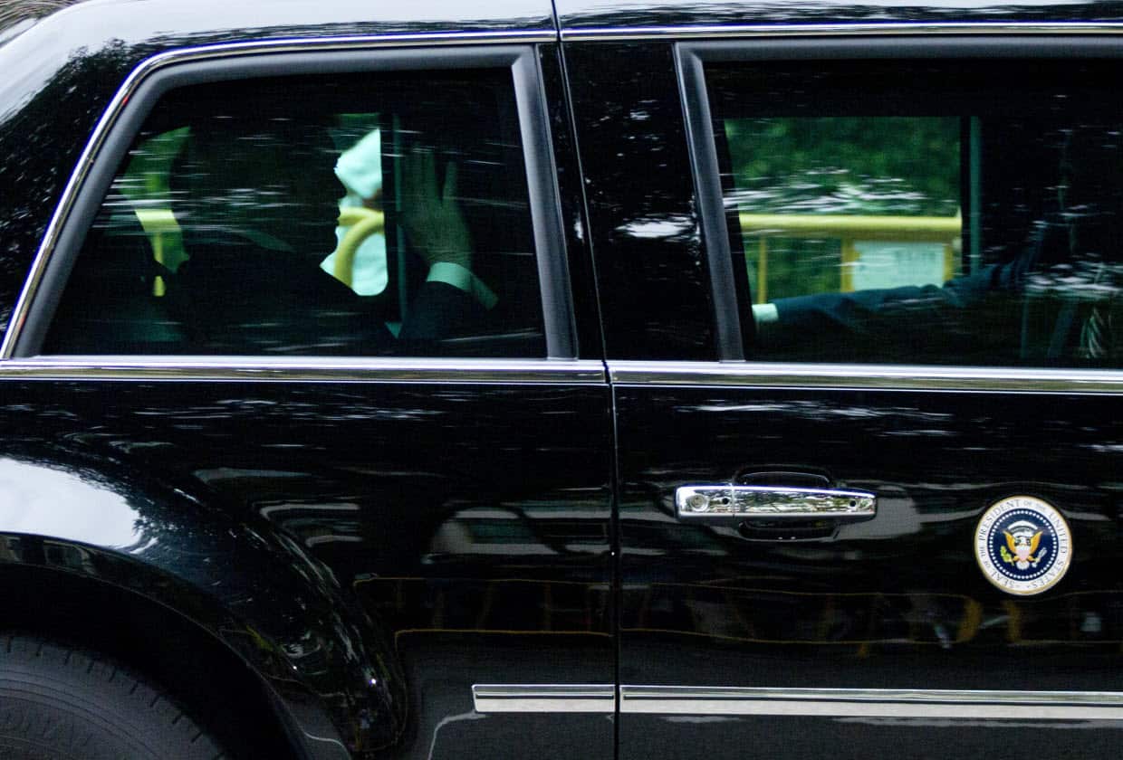 President Donald Trump waves as his motorcade leaves Shangri-La hotel in Singapore Tuesday, June 12.