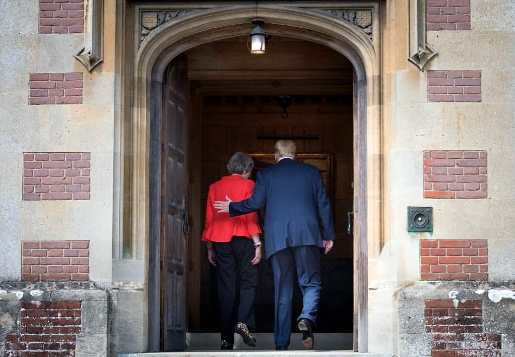 Prime Minister Theresa May and US President Donald Trump walk through the doors at Chequers.