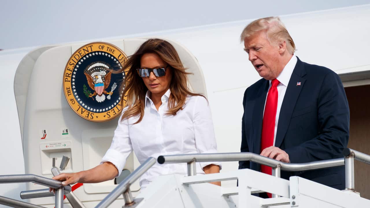 President Donald Trump and first lady Melania Trump arrive on Air Force One at Morristown Municipal Airport.