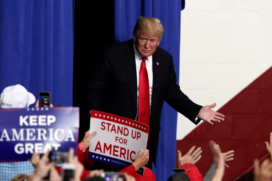 President Donald Trump takes the stage to speak at a campaign rally in Indianapolis.