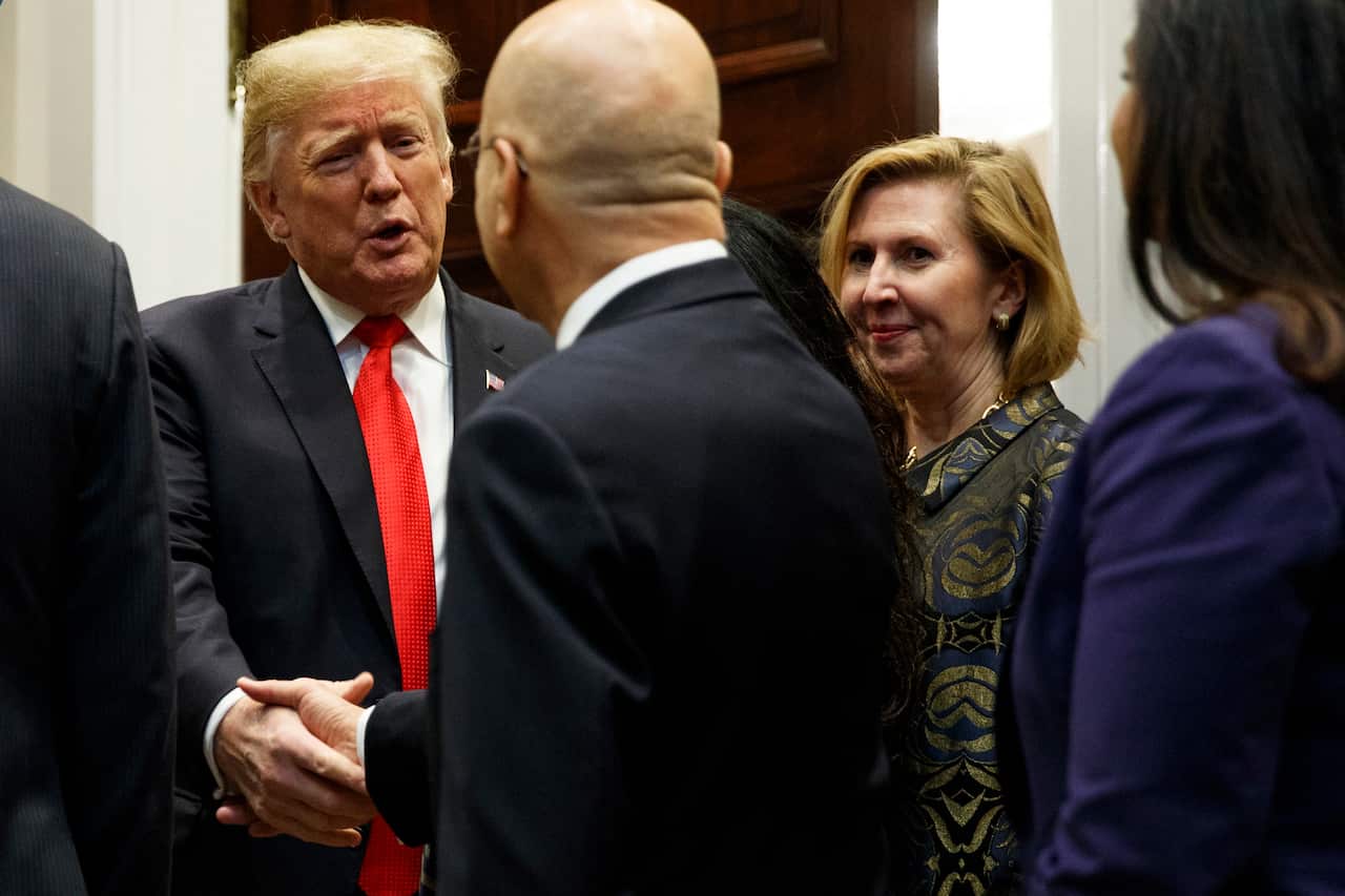 Outgoing deputy National Security Advisor Mira Ricardelas watches as Donald Trump arrives for a Diwali ceremonial lighting of the Diya in the White House.