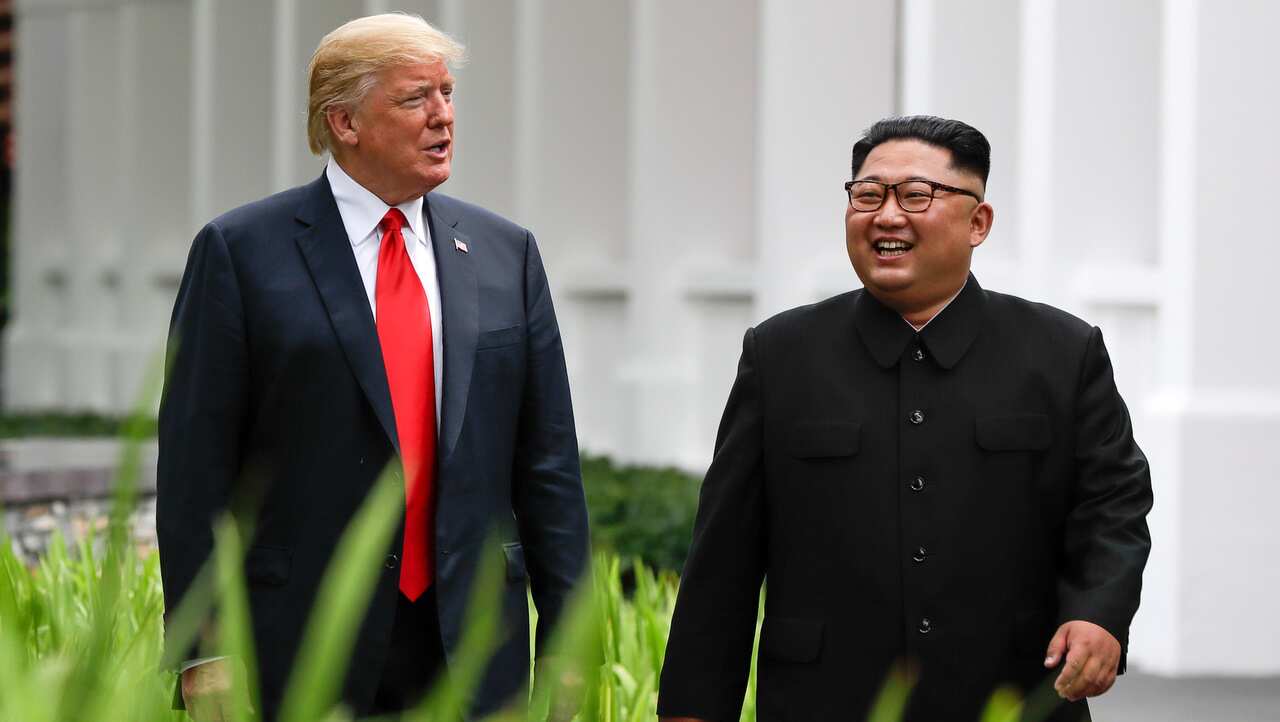 US President Donald Trump and North Korea leader Kim Jong Un walk from their lunch at the Capella resort on Sentosa Island in Singapore.