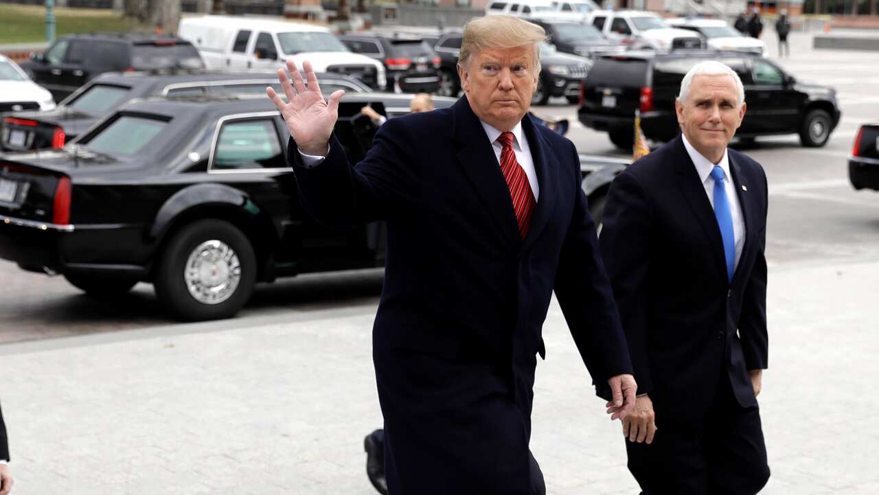 President Donald Trump walks with Senate Majority Leader Mitch McConnell.