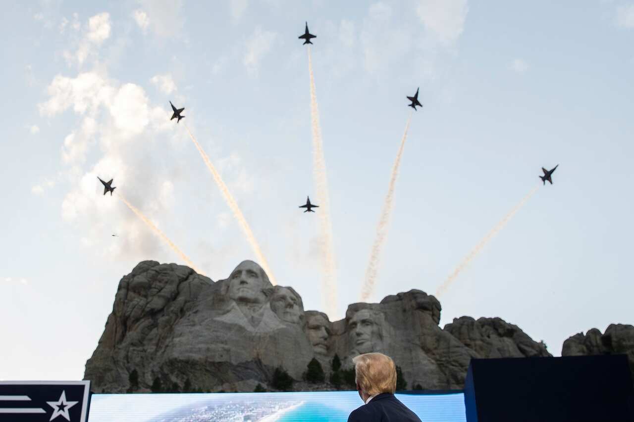 President Donald Trump watches a flyover by the US Navy Blue Angles at Mount Rushmore National Memorial.