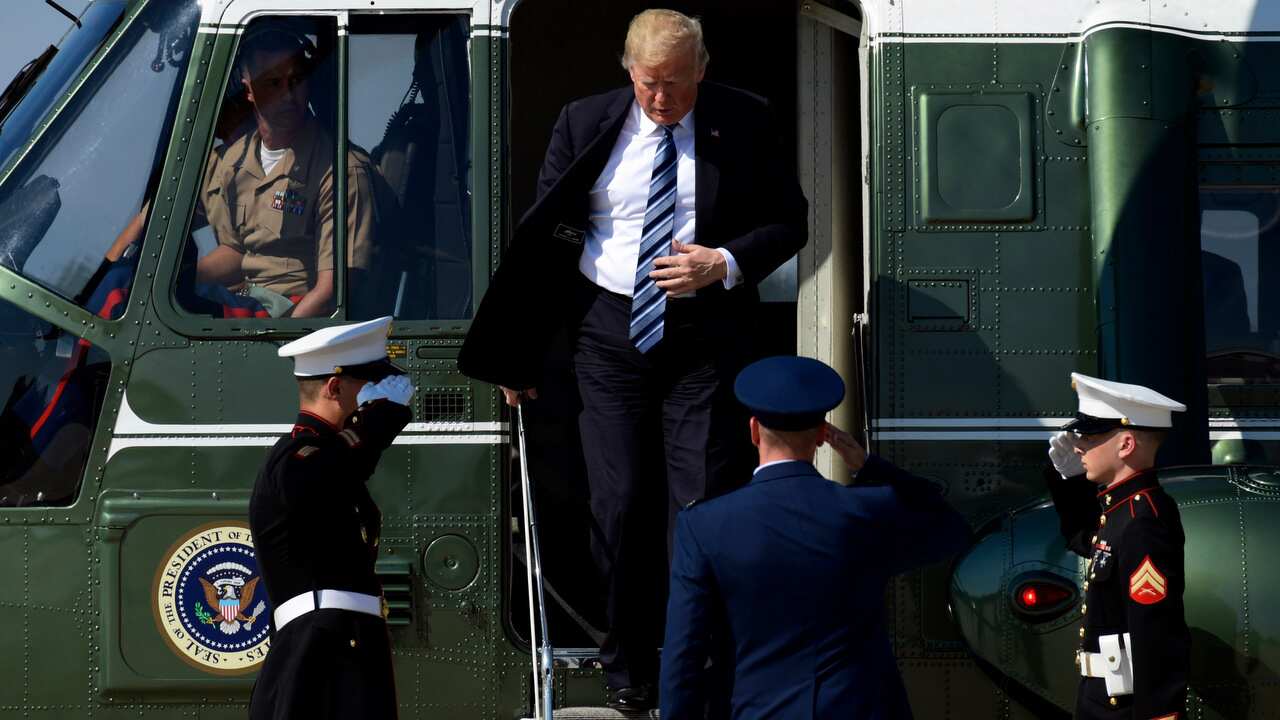 President Donald Trump walks off of Marine One as he heads to Air Force One at Andrews Air Force Base.