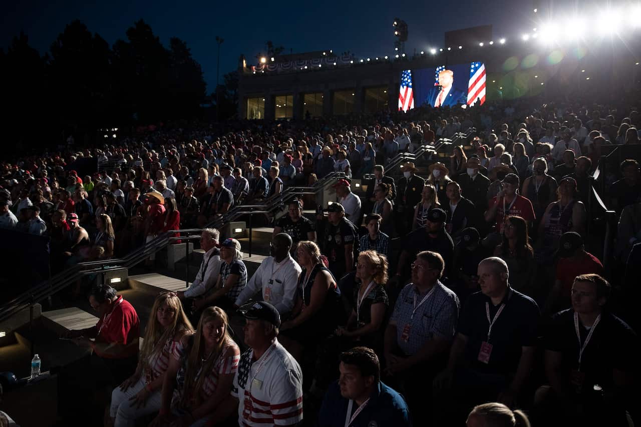Supporters watch as President Donald Trump speaks at Mount Rushmore National Memorial.