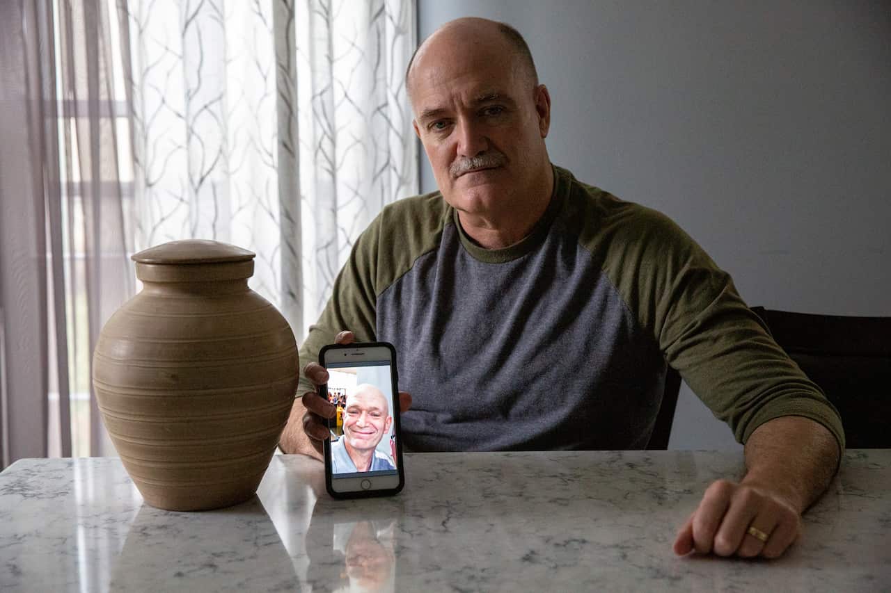 Russell Blatt shows a photo of his brother, Stacy