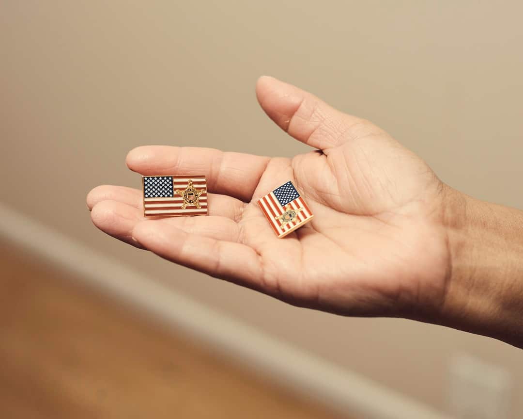 Victorina Morales holds American flag pins with a Secret Service logo, which she said she was asked to wear during President Donald Trumps visits to the Trump National Golf Club in Bedminster, N.J., at her home in Bound Brook, N.J.