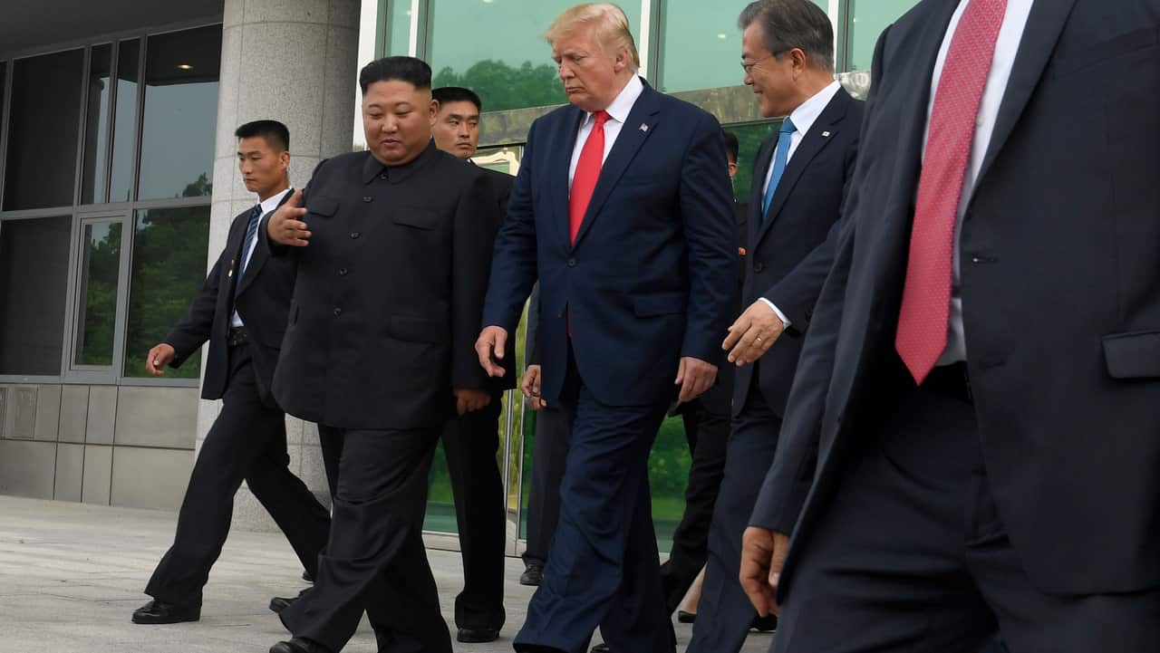 President Donald Trump and North Korean leader Kim Jong Un walk out of Freedom House at the border village of Panmunjom.
